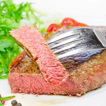 Steak with salad Stock Photos