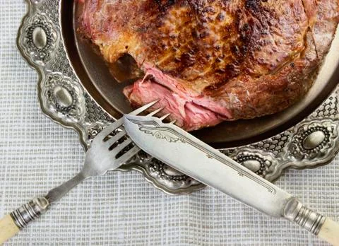 Steak on silver plate Stock Photos