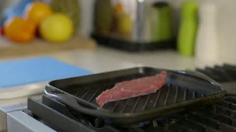 Steak sizzling in griddle pan Stock Footage 22040656