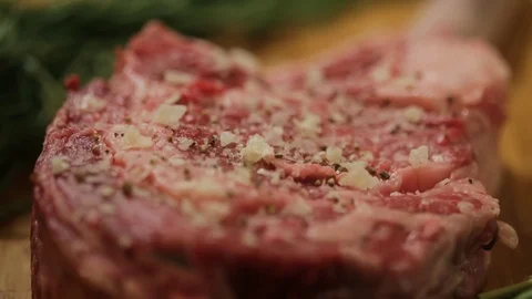 Steak sprinkling salt close up Video stock 103676562