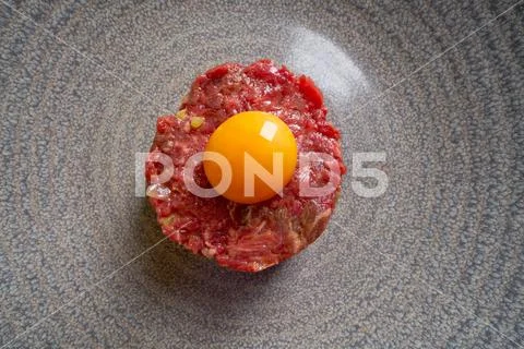 Steak Tartare raw meat recipe with egg yolk Stock Photos
