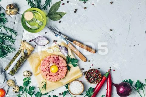 Steak tartare with yolk and set of cutlery knife Stock Photos