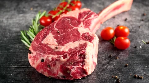 Steak Tomahawk rib eye, Irish beef, with tomatoes Stock Footage 194996881