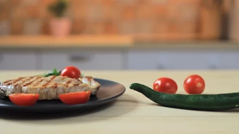Steak with vegetables on the dark plate Stock Footage 124638699