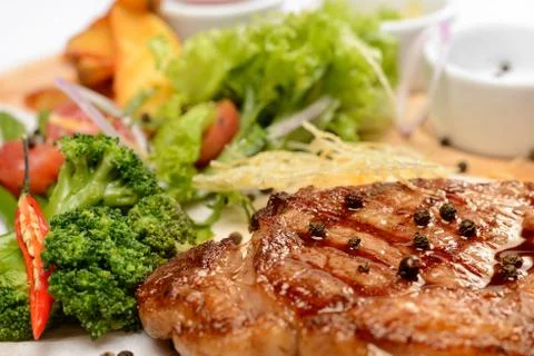 Steak with vegetables Stock Photos