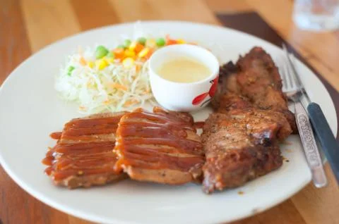 Steak in white disk soft light Stock Photos