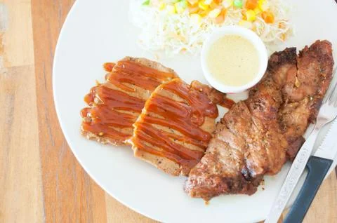 Steak in white disk soft light Stock Photos