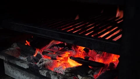 Steakhouse. The chef prepares a Josper grill with coals for searing steaks. Stock Footage 325081981