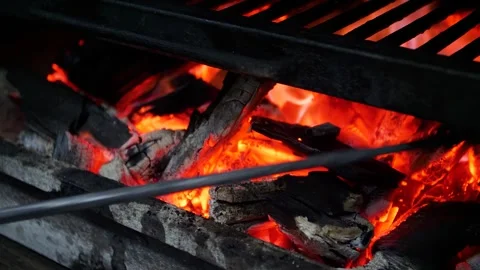 Steakhouse. The chef prepares a Josper grill with coals for searing steaks. Stock Footage 325082017
