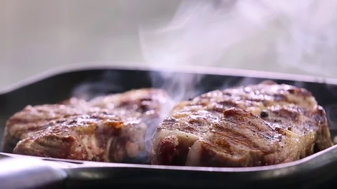 Steaks are fried in a pan Stock Footage 74428135