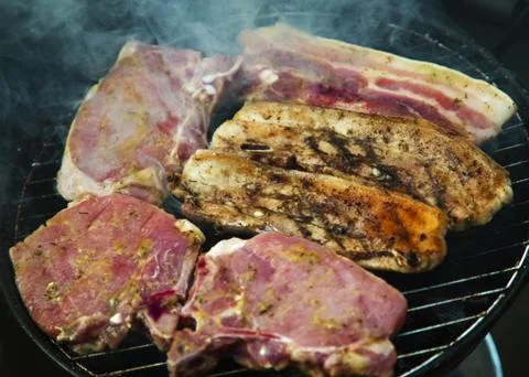 Steaks on barbecue Stock Photos