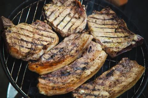 Steaks on barbecue Stock Photos