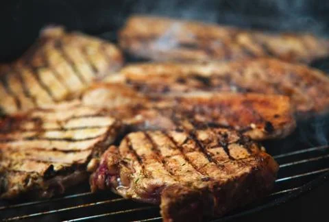 Steaks on barbecue Stock Photos