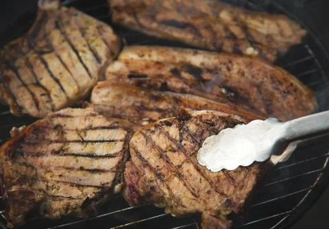 Steaks on barbecue Stock Photos