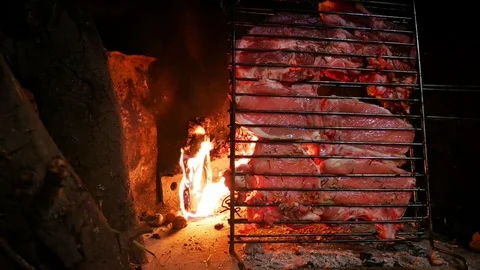 Steaks being cooked in front of a home fireplace Stock Footage 127299155