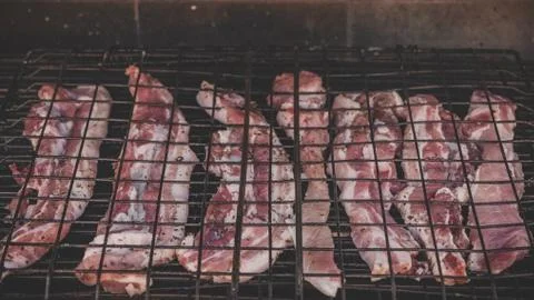Steaks at the grill cooking Stock Photos