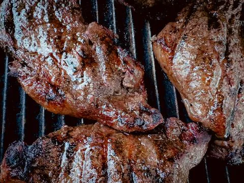 Steaks on a grill Stock Photos