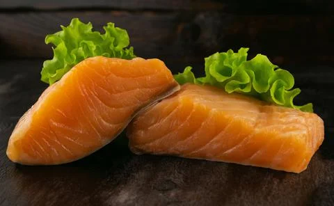Steaks of lightly salted red fish with herbs Stock Photos