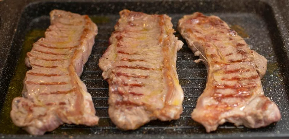 Steaks in the pan Stock Photos