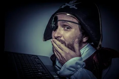 Stealing, computer security, hacker pirate dress with hat and skull Stock Photos