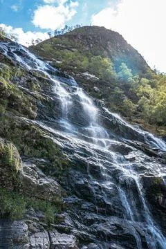 The Steall Falls waterfall cascading down a rugged mountain in Glen Nevis Stock Photos