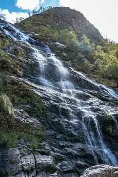 The Steall Falls waterfall cascading down a rugged mountain in Glen Nevis Stock Photos