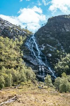 The Steall Falls waterfall cascading down a rugged mountain in Glen Nevis Stock Photos