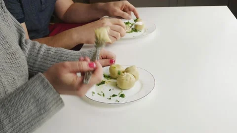 Steals from another dish.Quietly picks up a fork dumpling.Food on white plates. Stock-Footage 131357605