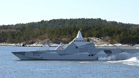 Stealth corvette in archipelago Stock Footage 87390922