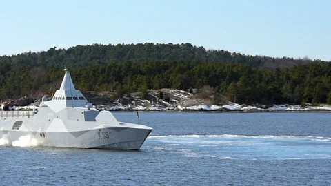 Stealth corvette in archipelago Stock Footage 87391102