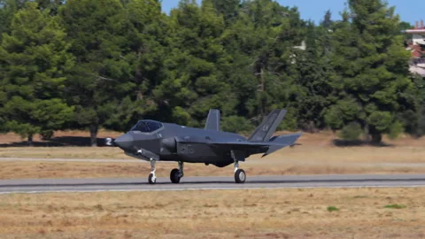 Stealth Fighter Landing Close-Up Side View Perfect for War News or Documentaries Stock Footage 296062723