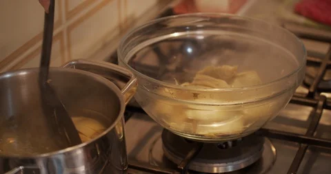 Steam and condensation while Drain artichokes from the Boiling Water Stock Footage 128954141