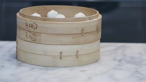 Steam basket with dumplings on a marble table Stock Footage 342382926