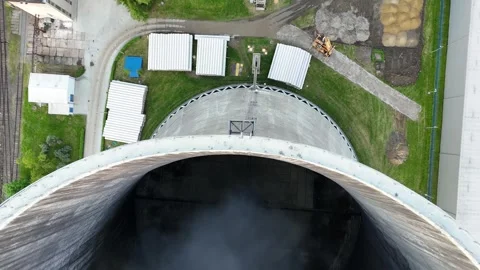 Steam billows from the interior of a thermal power plant cooling tower Stock Footage 341470312