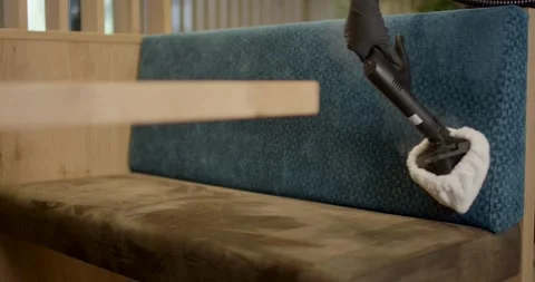 Steam Cleaner Head Glides Over Blue Upholstered Backrest 動画素材 340277498