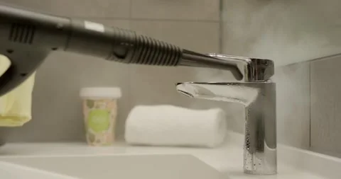 Steam Cleaner Refreshing a Bathroom Chrome Faucet With Hot Steam Stock Footage 340271546