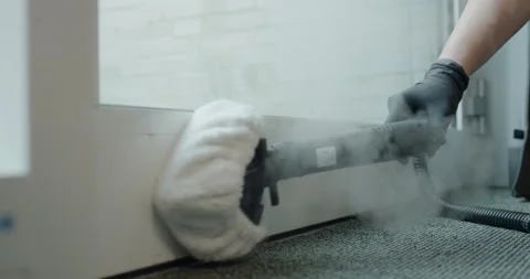 Steam Cleaner Thoroughly Cleaning Wall Baseboard With Hot Steam Vídeo Stock 340273565