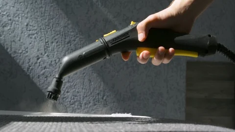 Steam cleaning a sofa with Karcher device. Home cleaning concept. Stockbeeldmateriaal 92192681