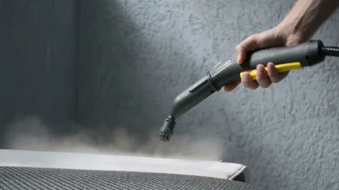 Steam cleaning a sofa with Karcher device. Home cleaning concept. Stockbeeldmateriaal 92192973