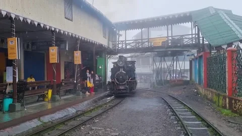 Steam coal engine reversing out of the ghum ghoom station near Darjeeling Stock Footage 249165933