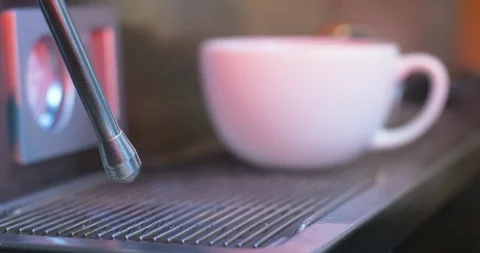 Steam from coffee machine wand close-up with a cup Stockbeeldmateriaal 122370886