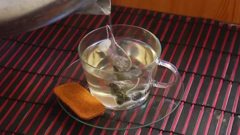 Steam coming from a hot cup of tea inside home Stock Footage 200230965