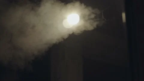 Steam coming out of a pipe in the light of a lamp. Energy concept. Design Stock Footage 202022438