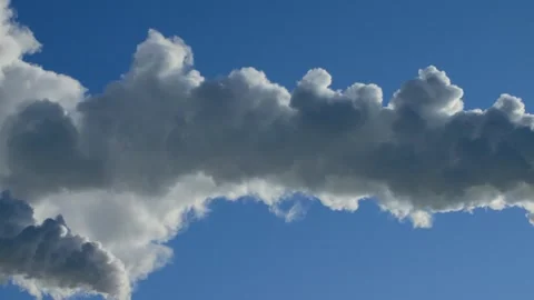 Steam coming out of two chimneys against a clear blue sky. Factory smokestacks. Stock Footage 328704697