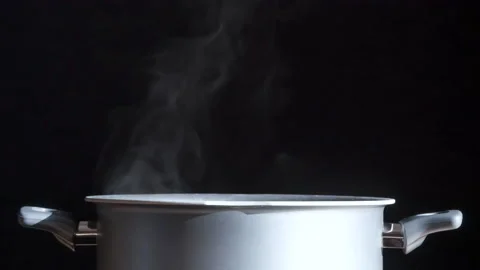 Steam Curls Gracefully from the Pan HD Pro Stock Footage 131151357