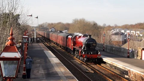 Steam engine 45699 'Galatea' and excursion train arrives at Appleby station. Stock Footage 86521756