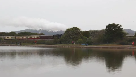 Steam engine 60103 Flying Scotsman hauling 'The Ynys Mon Express' train, Rhyl Stock Footage 141582205