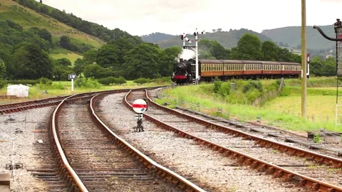 Steam Engine and Carriages Arriving at a Station Stock Footage 78670755