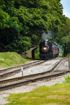 Steam Engine with Passenger Train Pulling into Station pt 1 스톡 사진