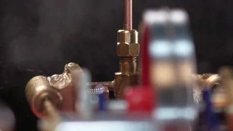 Steam Engine - tight tilt up from engine in motion into steam Stock Footage 84070325